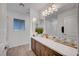 Modern bathroom features a dual sink vanity, large mirror, and sleek fixtures at 7756 Seville Estates Ct, Las Vegas, NV 89113