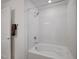 Bathroom with tub and shower combination featuring white quartz surround at 7756 Seville Estates Ct, Las Vegas, NV 89113