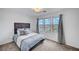Cozy bedroom with soft carpeting, plush bed, and bright natural light at 7756 Seville Estates Ct, Las Vegas, NV 89113