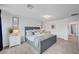 Serene primary bedroom featuring neutral tones, soft carpet, and ample natural light from large windows at 7756 Seville Estates Ct, Las Vegas, NV 89113