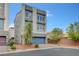 Contemporary two-story home featuring a grey stucco facade, a two-car garage, and a well-manicured front yard at 7756 Seville Estates Ct, Las Vegas, NV 89113