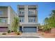 Contemporary two-story home featuring a grey stucco facade, a two-car garage, and a well-manicured front yard with brick pavers at 7756 Seville Estates Ct, Las Vegas, NV 89113