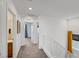 Bright hallway features white walls, plush carpeting, and easy access to bedrooms at 7756 Seville Estates Ct, Las Vegas, NV 89113