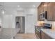Well-equipped kitchen featuring stainless appliances, granite counters, gas range, and ample storage within easy reach of stainless fridge at 7756 Seville Estates Ct, Las Vegas, NV 89113