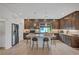 Modern kitchen with stainless steel appliances, ample storage, and a center island with bar stools at 7756 Seville Estates Ct, Las Vegas, NV 89113