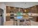 Updated kitchen features stainless steel appliances, island with breakfast bar, and custom cabinetry at 7756 Seville Estates Ct, Las Vegas, NV 89113
