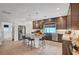 Gourmet kitchen with stainless steel appliances, granite countertops, and a large island with seating at 7756 Seville Estates Ct, Las Vegas, NV 89113