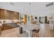 Open-concept kitchen with granite counters, stainless appliances, and a breakfast bar overlooking the dining and living areas at 7756 Seville Estates Ct, Las Vegas, NV 89113