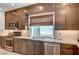 Gourmet kitchen boasting modern appliances, granite countertops, custom cabinets, and a window over the sink at 7756 Seville Estates Ct, Las Vegas, NV 89113
