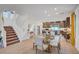Bright view of kitchen and dining area with hardwood floors and a large staircase at 7756 Seville Estates Ct, Las Vegas, NV 89113