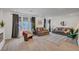 Bright and open living room with hardwood floors, comfortable seating, and large windows with modern curtains at 7756 Seville Estates Ct, Las Vegas, NV 89113