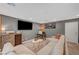 Stylish living room featuring a sectional sofa, a modern TV, a small bar, and well-placed decor at 7756 Seville Estates Ct, Las Vegas, NV 89113