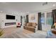 Cozy living room featuring a modern fireplace and large windows with natural light at 7756 Seville Estates Ct, Las Vegas, NV 89113