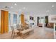 Spacious open-concept living and dining area with fireplace and hardwood floors, perfect for entertaining at 7756 Seville Estates Ct, Las Vegas, NV 89113