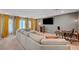 Spacious living room with a large sectional sofa, a modern TV, and stylish decor at 7756 Seville Estates Ct, Las Vegas, NV 89113
