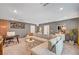 Stylish living room featuring a sectional sofa, a modern TV, a small bar, and well-placed decor at 7756 Seville Estates Ct, Las Vegas, NV 89113