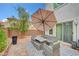 Cozy patio with brick pavers, stylish furniture sets, and shade umbrellas at 7756 Seville Estates Ct, Las Vegas, NV 89113