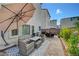 Cozy patio with brick pavers, stylish furniture sets, and shade umbrellas at 7756 Seville Estates Ct, Las Vegas, NV 89113