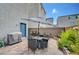 Cozy patio with brick pavers, stylish furniture sets, and shade umbrellas at 7756 Seville Estates Ct, Las Vegas, NV 89113