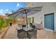 Cozy patio with brick pavers, stylish furniture sets, and shade umbrellas at 7756 Seville Estates Ct, Las Vegas, NV 89113
