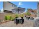 Cozy patio with brick pavers, stylish furniture sets, and shade umbrellas at 7756 Seville Estates Ct, Las Vegas, NV 89113