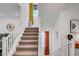 Carpeted staircase with white railing, window for natural light, and convenient access between floors at 7756 Seville Estates Ct, Las Vegas, NV 89113