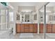 Well-lit bathroom with double sinks, vanities, and a large mirror at 7852 Running Doe Ct, Las Vegas, NV 89149