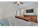 Comfortable bedroom with a ceiling fan, TV, dresser, and access to bathroom at 7852 Running Doe Ct, Las Vegas, NV 89149