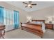 Bedroom featuring a large wood bed frame, ceiling fan, and ample natural light at 7852 Running Doe Ct, Las Vegas, NV 89149