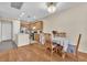 Cozy dining area adjacent to the kitchen with wood floors and natural lighting at 7852 Running Doe Ct, Las Vegas, NV 89149