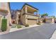 Exterior view showcasing the two-story home with a two-car garage and stairway at 7852 Running Doe Ct, Las Vegas, NV 89149