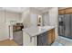 Well-lit kitchen area featuring stainless steel appliances and a breakfast bar with sink and dishwasher at 7852 Running Doe Ct, Las Vegas, NV 89149