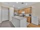 Well-lit kitchen with island, stainless steel appliances, and ample cabinet space at 7852 Running Doe Ct, Las Vegas, NV 89149