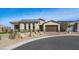Stylish single-story home featuring desert landscaping, a brown metal roof, and brick-paved driveway at 796 Windover Ct, Las Vegas, NV 89138