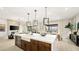 Open-concept kitchen with a large island, seating, and modern pendant lighting fixtures at 796 Windover Ct, Las Vegas, NV 89138