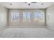 Large bedroom with new carpet and multiple windows at 7973 Macklin St, Las Vegas, NV 89129