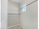 Carpeted walk-in closet with hanging rods and a window for natural light at 7973 Macklin St, Las Vegas, NV 89129