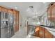 Modern kitchen features wood cabinets, granite countertops, stainless steel appliances, and sleek design at 7973 Macklin St, Las Vegas, NV 89129