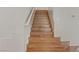 Modern wooden staircase with bright white painted risers and walls at 7973 Macklin St, Las Vegas, NV 89129