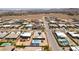 This aerial view displays properties with swimming pools and basketball courts in a desert planned community at 7998 W Ford Ave, Las Vegas, NV 89113