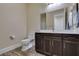 Bathroom features a spacious vanity with a large mirror and a separate toilet area at 7998 W Ford Ave, Las Vegas, NV 89113