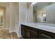 Bathroom with quartz countertops, wood cabinets, large mirrors, and views into the water closet at 7998 W Ford Ave, Las Vegas, NV 89113