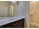 Bathroom featuring a modern vanity with white countertop and dark wood cabinets at 7998 W Ford Ave, Las Vegas, NV 89113