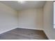 Bedroom featuring neutral walls, wood floors, white trim, and a ceiling light at 7998 W Ford Ave, Las Vegas, NV 89113