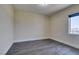 Empty bedroom featuring wood floors, neutral walls, white trim, and a blue window shade at 7998 W Ford Ave, Las Vegas, NV 89113