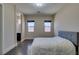 Bright bedroom with wood floors, complemented by a view into an adjacent bathroom at 7998 W Ford Ave, Las Vegas, NV 89113