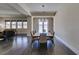 Spacious dining room with modern chandelier and seating for eight overlooking the backyard at 7998 W Ford Ave, Las Vegas, NV 89113