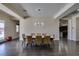 Well-lit dining room showcasing the modern chandelier and access to the kitchen area at 7998 W Ford Ave, Las Vegas, NV 89113