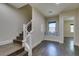 Inviting hallway with wood stairs, built-in seating and modern banister, complemented by hardwood floors at 7998 W Ford Ave, Las Vegas, NV 89113