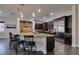 Gourmet kitchen boasts a large island with barstool seating, stainless steel appliances, and designer fixtures at 7998 W Ford Ave, Las Vegas, NV 89113
